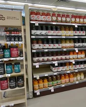 Supplement and grocery shelves inside Sunshine Co-op in Daytona Beach.